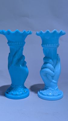 trois vases bleus posés les uns à côté des autres sur une table