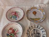 quatre assiettes ornées de motifs différents, posées sur une nappe blanche