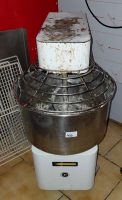 an image of a mixer in a kitchen with a red wall