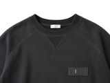a picture of a black sweatshirt with a leather patch on the chest