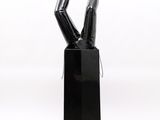 a black sculpture of a person with their legs up