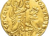 a gold coin with an image of a man holding a sword
