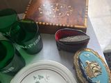 a table with a plate, cups, and a box on it