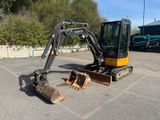 a small excavator that is parked in a parking lot