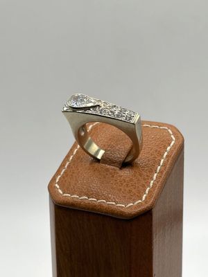 an image of a diamond ring on a wooden stand