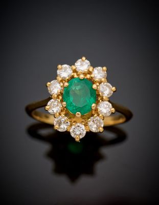 an emerald and diamond cluster ring
