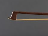 a close up of a violin bow on a gray background