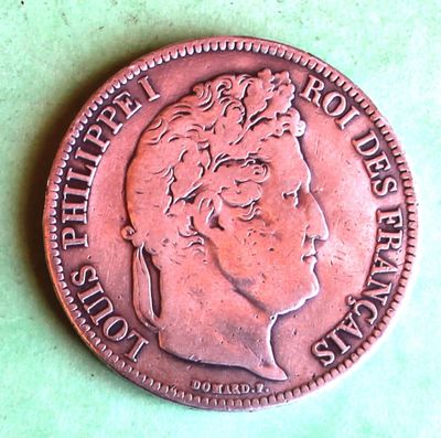 a close up of a coin on a green surface
