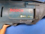 a close up of a drill on a blue surface