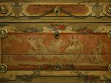 a chest of drawers that has a painting on it