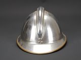 a silver helmet that is sitting on a table