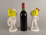 two figurines of a man and a woman with a bottle of wine