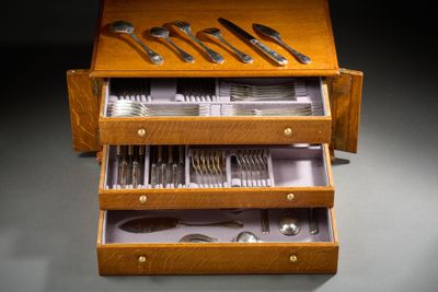 a wooden box with silverware in it on a table