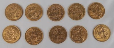a close up of a bunch of gold coins on a white surface