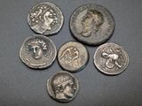 six ancient roman coins with heads and crowns on them