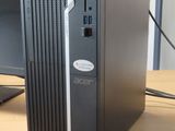 a desktop computer sitting on a desk in front of a monitor
