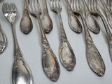 a lot of silver spoons and forks on the table