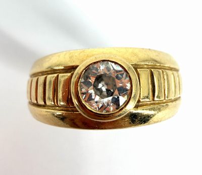 a close up of a gold ring with a diamond on it