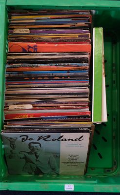 a green box filled with a lot of vinyl records