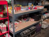 a red shelf with many items on it in a room