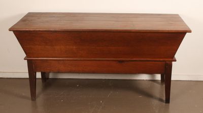 an old wooden chest sitting on top of a hard wood floor