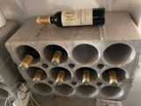 a bottle of wine sitting on top of a cinder block