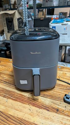 a small air fryer sitting on a table in a store