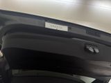 a car with its door open in a parking garage