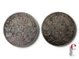 two silver coins with a coat of arms on them