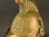 gold helmet on a stand with a black background