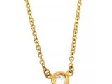 a gold necklace with a diamond on a chain