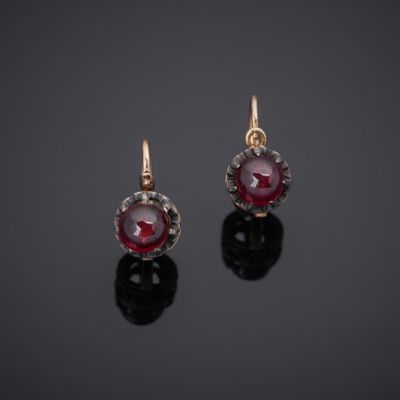 a pair of ruby and diamond earrings