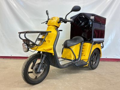 a yellow scooter with a cart on the back
