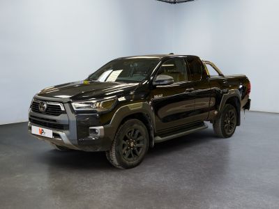 the black toyota tunder is parked in a large room