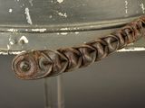 an old metal helmet with a chain attached to the side of it