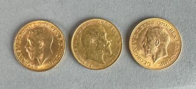 three gold sovereigns, one of which is a sovereign and one of which is a sovereign