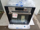 an oven with a price tag on it sitting on the ground