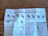 a piece of paper on a wooden table with a calculator next to it