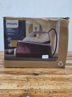 packaging of a philips steam iron sitting on a wooden table