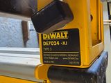 a close up of a yellow and black device on a window sill