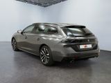 the rear view of a grey car in a showroom