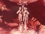 a picture of a silver plate with a statue on it