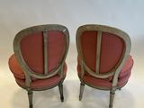 pair of antique chairs with red upholstered cushions