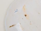 a dirty plate on the table with a knife and fork