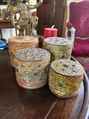 three decorative boxes are sitting on a table in a living room