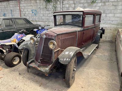 two old cars parked next to each other in a parking lot