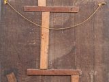 a wooden cross that is on the side of a building