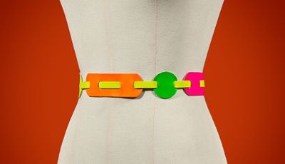 an image of a woman wearing a colorful belt with a green circle on it