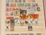 a book with stamps on the pages and a picture of a man