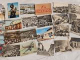 a lot of old postcards on the bed
